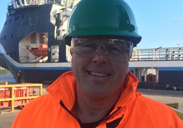 Spirit Energy's Richard Newby in orange work clothes and safety helmet