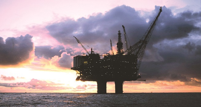 Oil rig in the sea at sunset